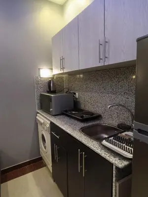 a kitchen with a sink and a microwave at Elite apartment private beach Holiday Chalet Free WIFI in Hurghada