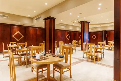 a restaurant with wooden walls and tables and chairs at Sunrise Alora Aqua Park Resort in Hurghada