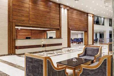 a lobby with a piano and a chair and a table at Sunrise Alora Aqua Park Resort in Hurghada