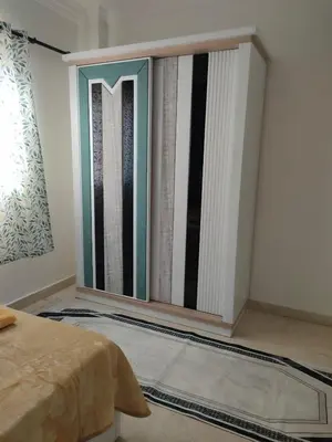 a bedroom with a large window in the wall at comfort marina 5 apartment,s in Hurghada