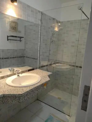a bathroom with a sink and a shower at comfort marina 5 apartment,s in Hurghada