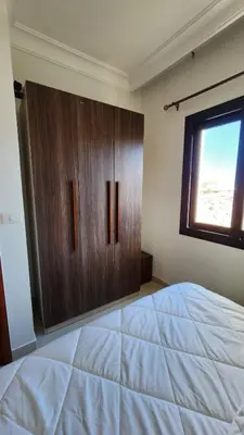 a bedroom with a large bed and a window at Apartment in the view 207 hill view in Hurghada