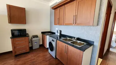 a kitchen with a sink and a washing machine at Apartment in the view 207 hill view in Hurghada