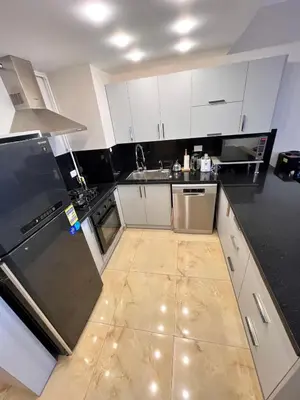 a kitchen with white cabinets and a counter top at One bedroom in Island View in Hurghada