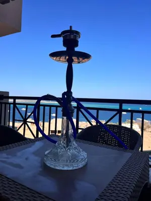 a lamp on a table with a view of the beach at One bedroom in Island View in Hurghada