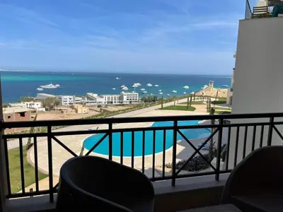 a balcony with a view of the ocean at One bedroom in Island View in Hurghada