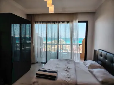 a bedroom with a bed with a view of the ocean at Studio for rent 206 in Hurghada