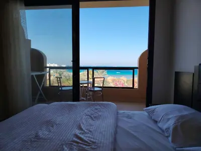 a bedroom with a bed and a view of the ocean at Studio for rent 206 in Hurghada