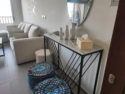 a living room with a table and a couch at Soma Breeze Sea and Golf view in Hurghada