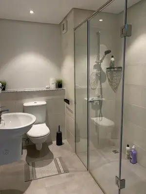 a bathroom with a shower and a toilet and a sink at Soma Breeze Sea and Golf view in Hurghada
