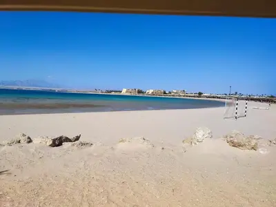 a beach with rocks in the sand and the ocean at Soma Breeze Sea and Golf view in Hurghada