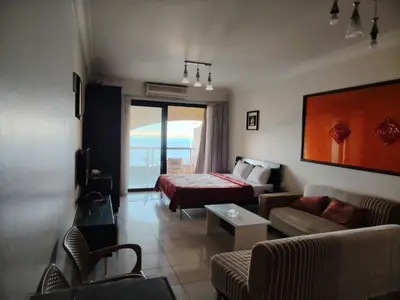 a living room with a couch and a bed in a room at Studio for rent in the view 114 in Hurghada
