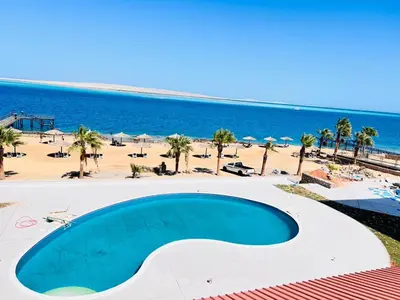 a large swimming pool in front of a beach at Studio for rent in the view 114 in Hurghada
