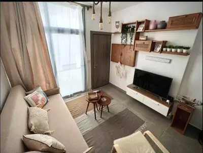 a living room with a couch and a television at Luxury One bedroom in gouna in Hurghada