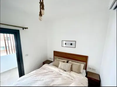 a bedroom with a bed with white sheets and pillows at Luxury One bedroom in gouna in Hurghada