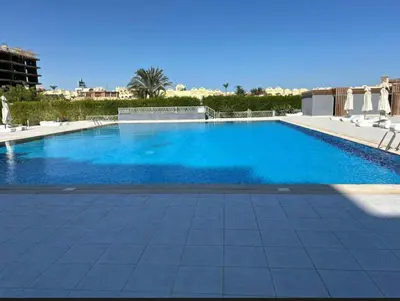 a large swimming pool with blue water at Scandic Resort Hurghada in Hurghada