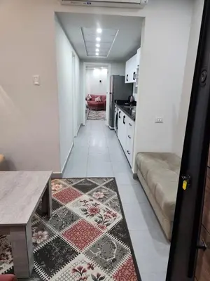 a living room with a couch and a kitchen at Scandic Resort Hurghada in Hurghada