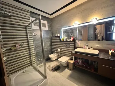 a bathroom with a shower and a toilet and a sink at Sky star 130 in Hurghada