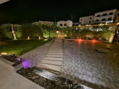 a stone walkway in a park at night at Sky star 130 in Hurghada