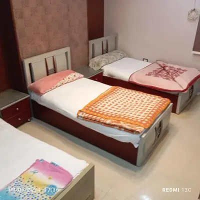 a room with three beds in a room at SuperElite apartment NileView F4 in Naj‘ al ‘Amrāb