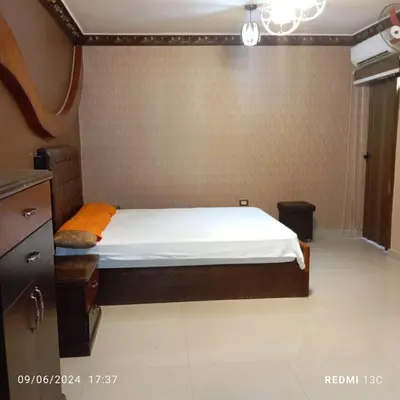 a bedroom with a bed in a room at SuperElite apartment NileView F4 in Naj‘ al ‘Amrāb