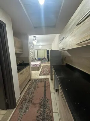 a kitchen with a black counter top in a room at Aldau heights 2 in Hurghada