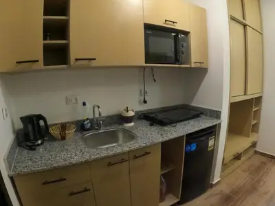 a kitchen with a sink and a microwave at Dive Hostel Hurghada Pool in Hurghada
