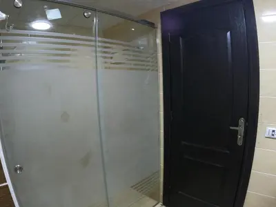 a shower with a glass door in a bathroom at Dive Hostel Hurghada Pool in Hurghada