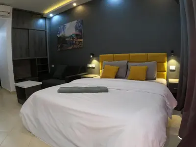 a bedroom with a large white bed with yellow pillows at Dive Hostel Hurghada Pool in Hurghada