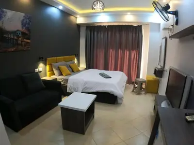 a hotel room with a bed and a couch at Dive Hostel Hurghada Pool in Hurghada