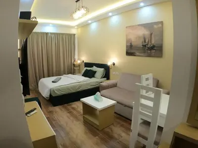 a hotel room with a bed and a couch at Dive Hostel Hurghada Pool in Hurghada