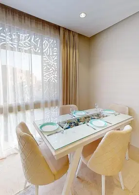 a dining room with a table and chairs and a window at 2bedroom in mangrove in gouna in Hurghada