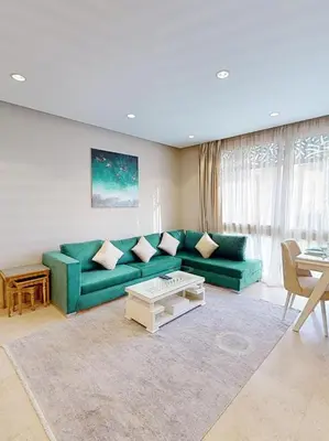 a living room with a green couch and a table at 2bedroom in mangrove in gouna in Hurghada