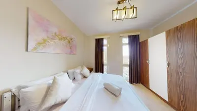 a bedroom with a white bed and a large window at 2bedroom in mangrove in gouna in Hurghada