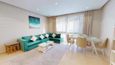 a living room with a green couch and a table at 2bedroom in mangrove in gouna in Hurghada