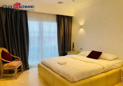 a bedroom with a large bed and a large window at Pretty 4Bedrooms Penthouse MB7 at New Abu Tig Marina in Hurghada