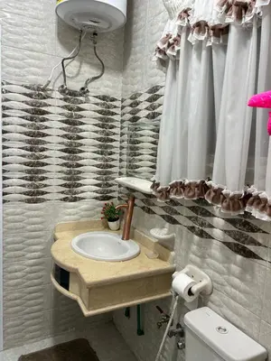 a bathroom with a sink and a toilet at Oscar Apartment 9 in Luxor