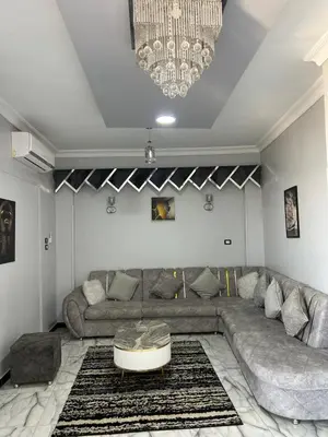 a living room with a couch and a table at Oscar Apartment 9 in Luxor