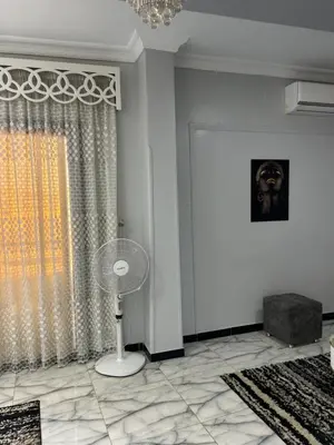 a white room with a fan and a window at Oscar Apartment 9 in Luxor