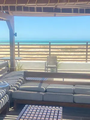 a row of benches in a building with a beach at Studio Imperial resort pool view in Hurghada