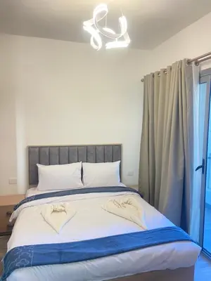 a bedroom with a large bed with a window at Studio Imperial resort pool view in Hurghada