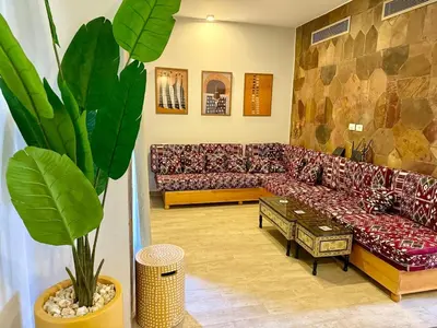 a living room with a couch and a table at Picturesque 3BR Villa- Free Lagoon Access ElGouna in Hurghada
