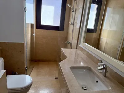 a bathroom with a sink and a toilet and a mirror at Picturesque 3BR Villa- Free Lagoon Access ElGouna in Hurghada