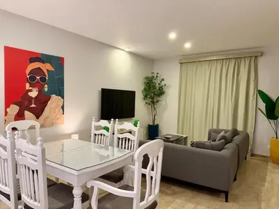 a living room with a table and a couch at Picturesque 3BR Villa- Free Lagoon Access ElGouna in Hurghada