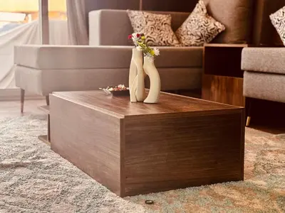 a living room with two vases with flowers on a table at Prestige Home apartment in Hurghada