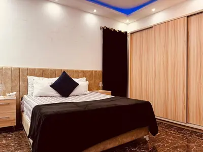 a bedroom with a bed with a blue ceiling at Prestige Home apartment in Hurghada