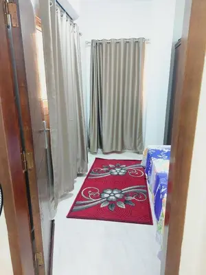 a room with a red rug on the floor at Wohnung in Al Ahyaa Hurghada in Hurghada