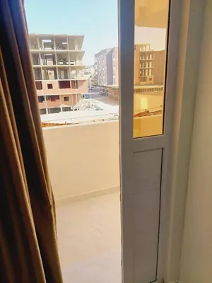 a window with a view of a building at Wohnung in Al Ahyaa Hurghada in Hurghada