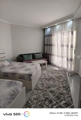a living room with two beds and a couch at Magnificent apartment in HRG With Beach Access, 5 Min from downtown in Hurghada