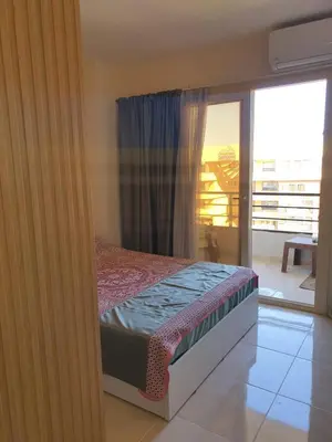 a bedroom with a bed and a balcony at Tiba golden resort in Hurghada